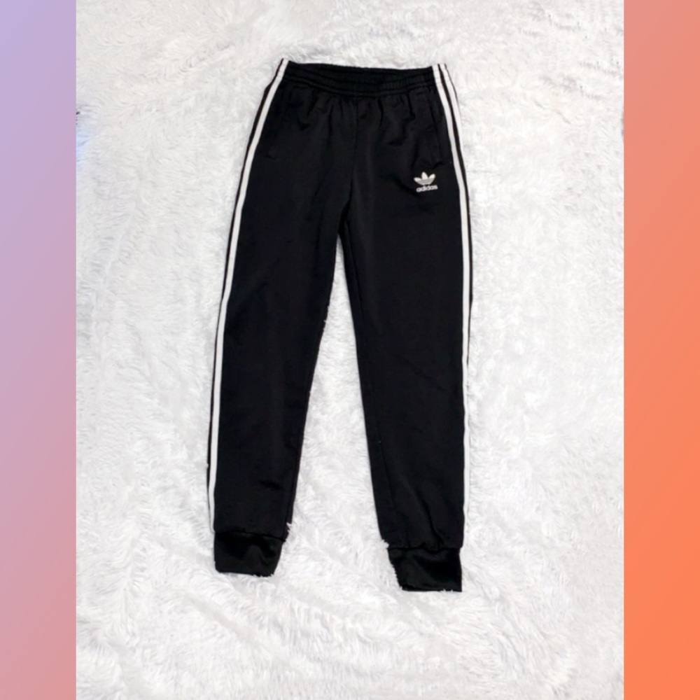 Adidas black fleece joggers cuffed at the ankles